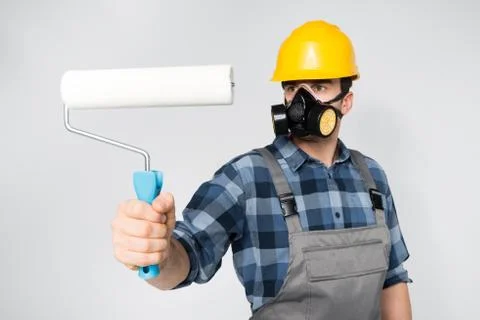 Construction worker with paint roller Stock Photos