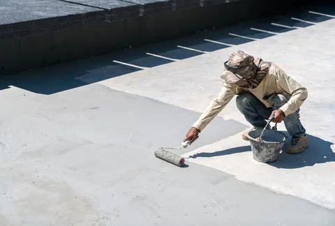 Construction worker paint water proof cement in pool. Stock Photos