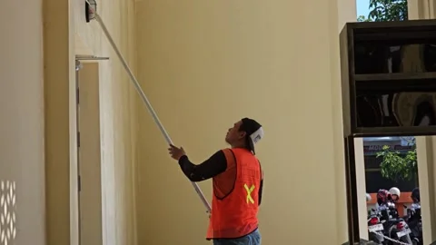 Construction Worker Painting Interior Wall With Roller On Extension Pole Stock Footage 340001611