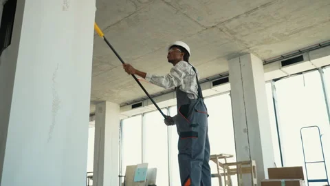 Construction worker painting walls with roller brush Stock Footage 312832575