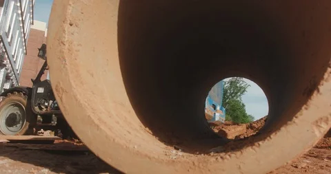 A construction worker passes across a job site and is visible through a Stock Footage 109530890
