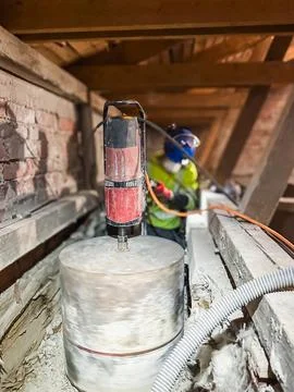 Construction worker performing large diameter core drilling in concrete slab. Stock Photos