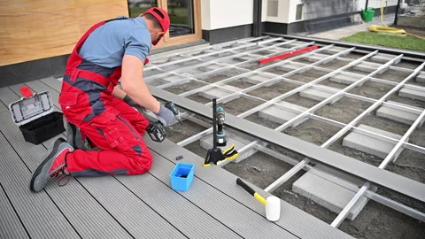 Construction Worker Performing Outdoor Decking Installation Stock Footage 274316356
