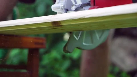 Construction Worker Performing Precise Cuts with Circular Saw Stock Footage 247523720
