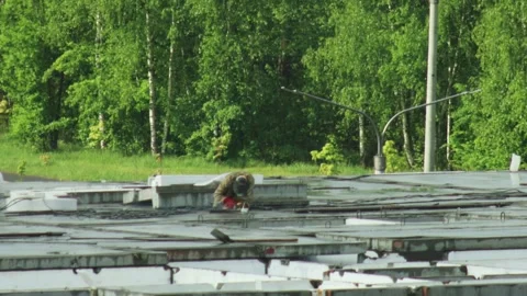 Construction worker performing task on concrete structure. Building site Stock Footage 339865827