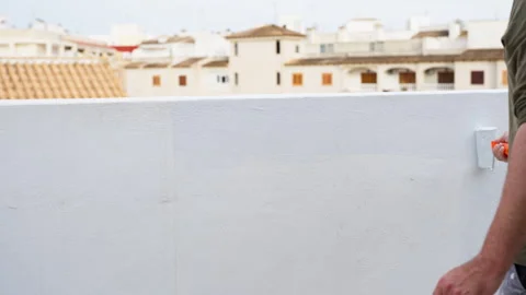 Construction worker performs exterior renovation by applying protective coa.. Stock Footage 334550711