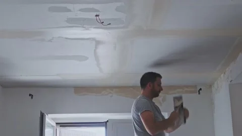 Construction worker performs a suspended ceiling maintenance with mineral fib Video stock 218619575