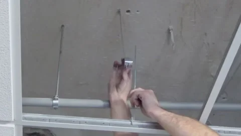 Construction worker performs a suspended ceiling maintenance with mineral fib Video stock 232238912