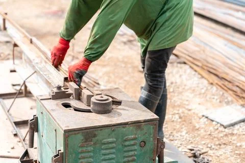 A construction worker in personal protective equipment operates a portable .. Stock Photos