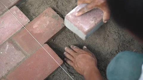 Construction Worker Placing Bricks on the ground Stock Footage 160036355