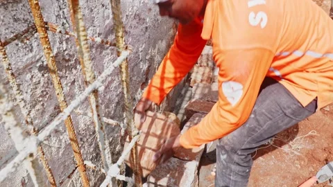 Construction worker placing granite stone in basement work at construction Stock Footage 331059655
