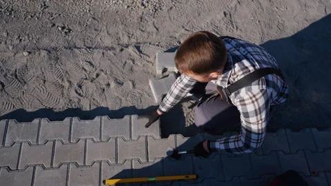 Construction Worker Placing Interlocking Pavers Stock Footage 297785926