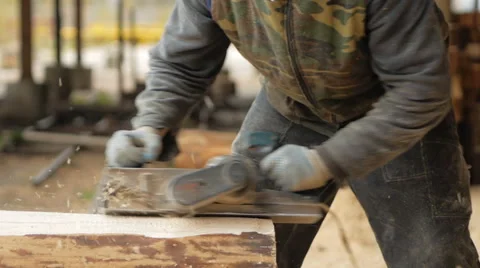 Construction worker planing a piece of wood for a building project. Construction Stock Footage 69002459