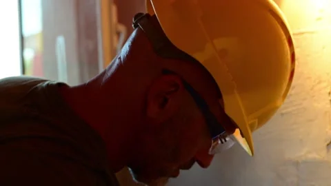 Construction worker plastering a concrete wall at a building site Stock Footage 346958859