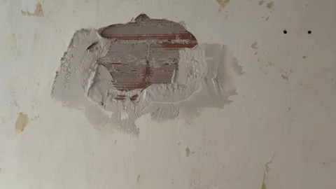 Construction worker plastering a damaged brick wall Stock Footage 341362935