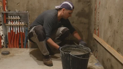 Construction worker is plastering wall and beam using cement plaster at the Stock Footage 86447548