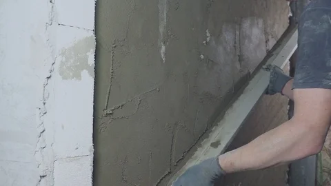 Construction worker is plastering wall and beam using cement plaster at the 스톡 동영상 122361398
