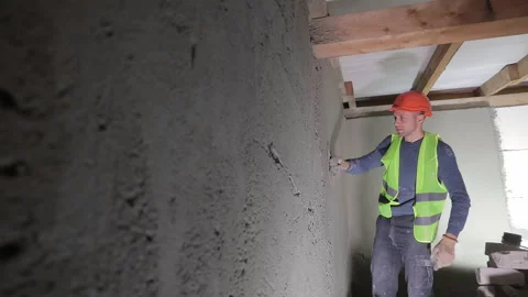 Construction worker plastering wall surface indoors, Worker applying plaster to Stock Footage 301280406