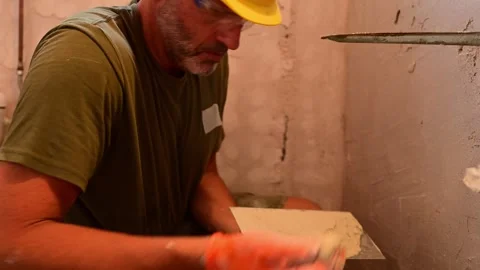 Construction worker plastering a wall with a trowel Video stock 346958757