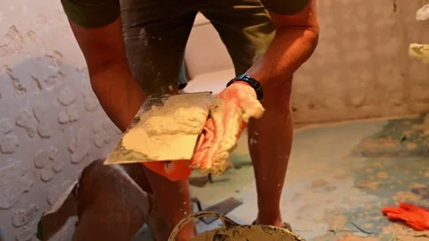 Construction worker plastering a wall with a trowel Stock Footage 346958866