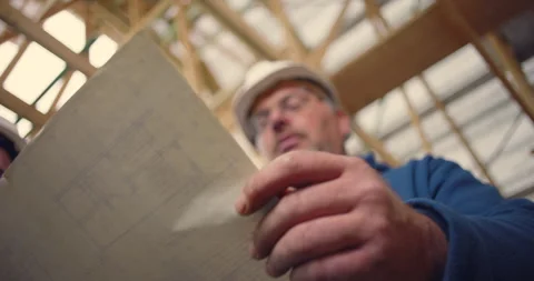Construction worker pointing at blueprint details, collaborating on archite.. 스톡 동영상 291713879