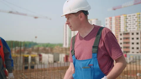 A construction worker is pointing at something on a construction site Stock Footage 265477147