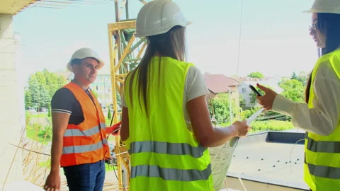 Construction worker points at object during inspection Stock Footage 317614069