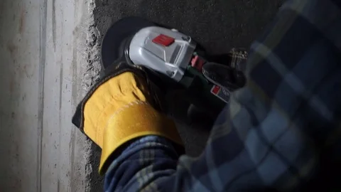 Construction worker polishes cement wall in a house Stock Footage 69806647