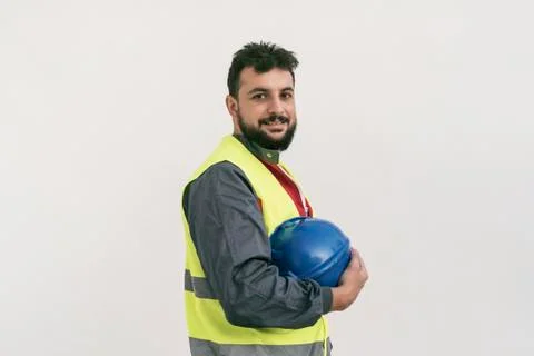 Construction worker portrait on white wall posing Stock Photos