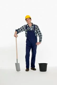 A construction worker posing with a shovel and bucket Stock Photos