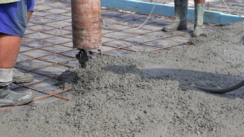 Construction worker pouring cement or concrete with pump tube. Reinforced steel Stock Footage 309121444