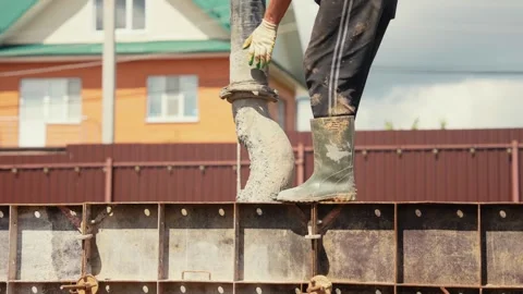 Construction worker pouring concrete into formwork Stock Footage 341294669