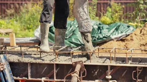 Construction worker pouring concrete into formwork Stock Footage 341294790
