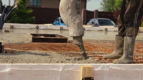 Construction worker pouring concrete foundation for house Stock Footage 341294433