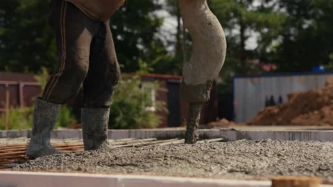 Construction worker pouring concrete on a foundation Stock Footage 341294612