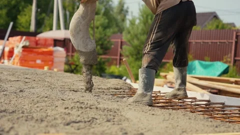 Construction worker pouring concrete foundation for house Stock Footage 341294692