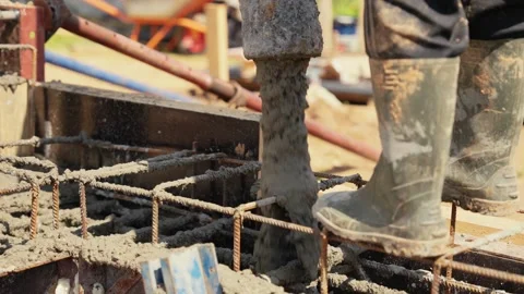 Construction worker pouring concrete into foundation formwork Stock Footage 341294762