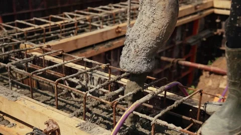 Construction worker pouring concrete into foundation formwork Stock Footage 341294829