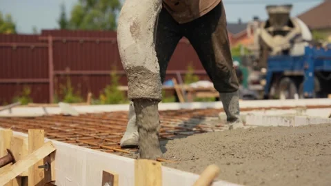 Construction worker pouring concrete for house foundation Stock Footage 341294563