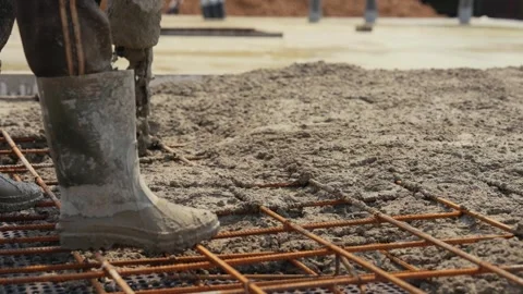 Construction worker pouring concrete on rebar foundation Stock Footage 341294668
