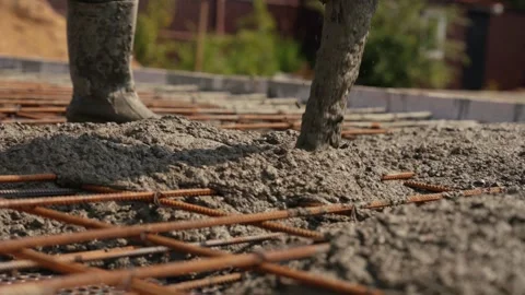 Construction worker pouring liquid concrete on rebar mesh Stock Footage 341294626