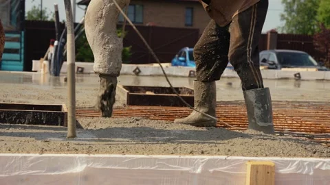 Construction worker pouring wet cement on a building foundation Stock Footage 341294447
