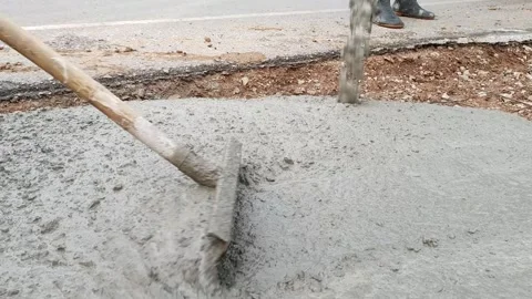 A construction worker pouring a wet concret at road construction site Stock Footage 244589112