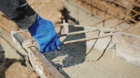 Construction worker pours wet concrete into foundation using chute. Stock-Footage 334664438