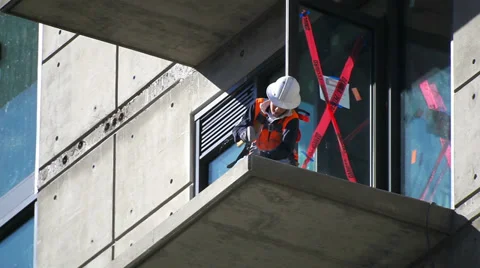Construction worker prepares balcony floor for installation at development site Stock Footage 34141334