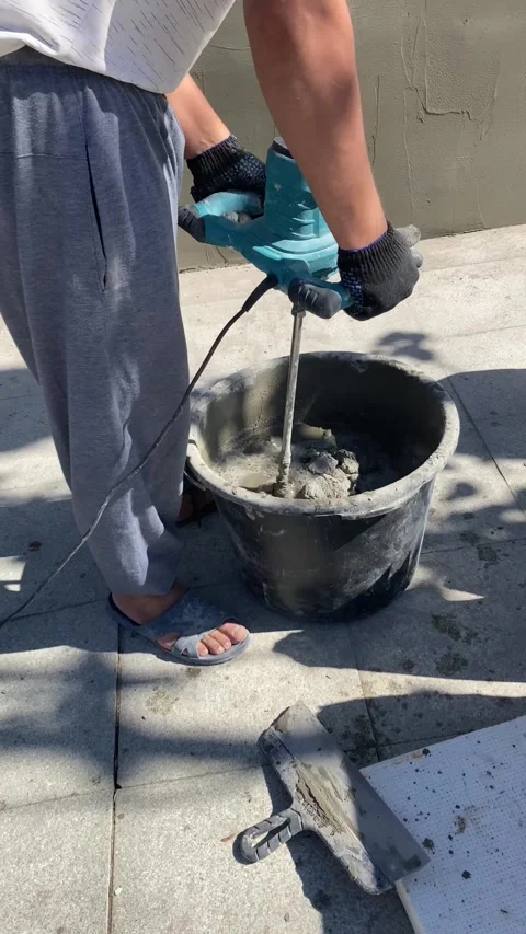 Construction worker prepares cement mixture Stock Footage 314535590