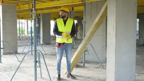 Construction worker preparing and carrying wooden beam Stock Footage 343450247
