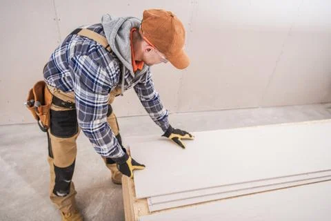 Construction Worker Preparing Building Materials.  Photos