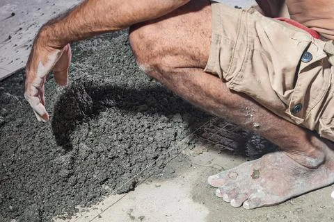 Construction Worker Preparing Concrete Material at Building Site copy Stock Photos