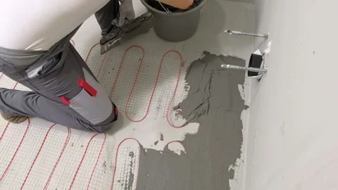 Construction worker preparing tile surface, mixing mortar substrate for flooring Stock Footage 328609224